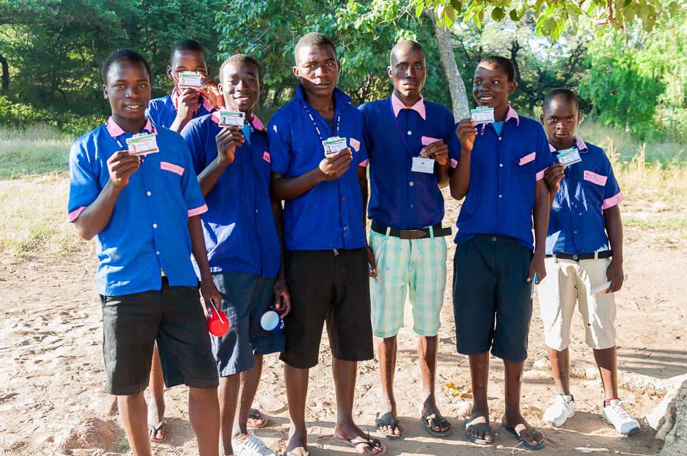 A group of standard 8 boys from Kazembe Primary School proudly display their Malawi National Examinations Board IDs which are necessary to gain admission to their Primary School Leaving Certificate of Education Exams.