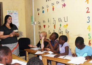 Teacher listening as kids pose questions.