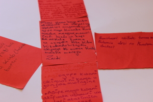Red paper in a ribbon patter with text