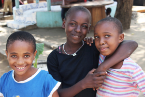 Three Children's Home girls smiling for camera