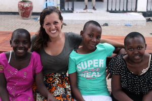 Three Children's Home girls and Molli on a bench